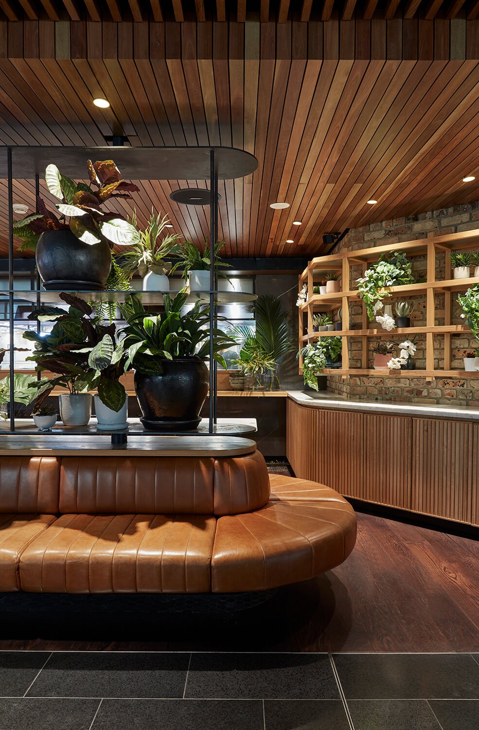 Leather booth seating with lush greenery
