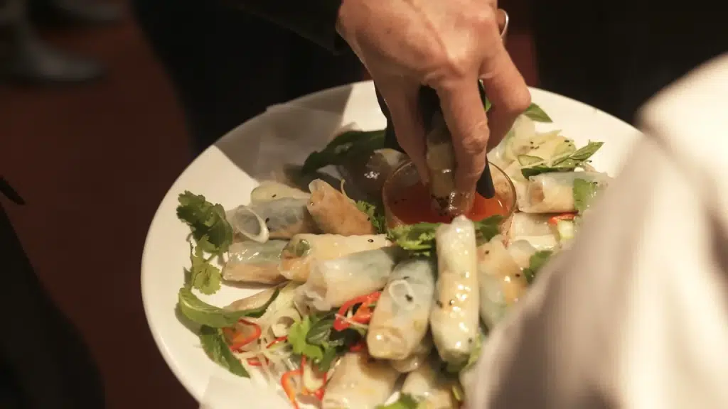 A shared dish being served at the table