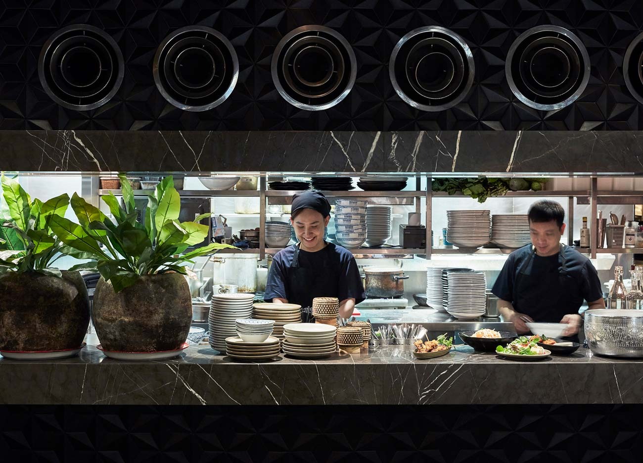 Chefs preparing dishes in the open kitchen